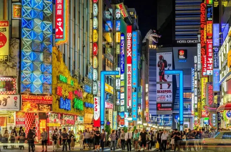 Private luxury vehicle driving past iconic Tokyo landmarks like Shibuya Crossing and Meiji Shrine